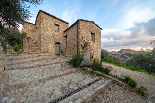 an external view of a stone building with stairs at Agriturismo C'era Una Volta in Camporosso