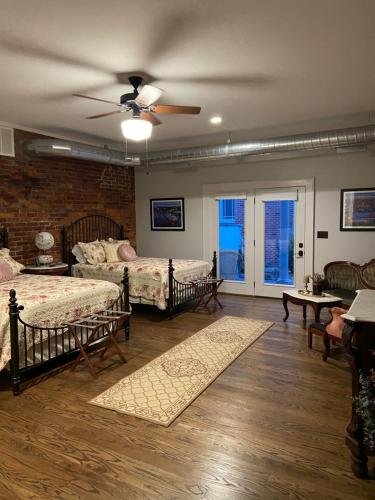 1 dormitorio con 2 camas y ventilador de techo en Belle Louise Historic Bed & Breakfast, en Paducah