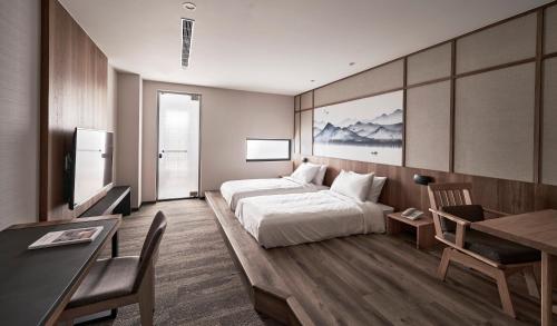 a hotel room with a bed and a desk at Yen Hotspring in Ruisui