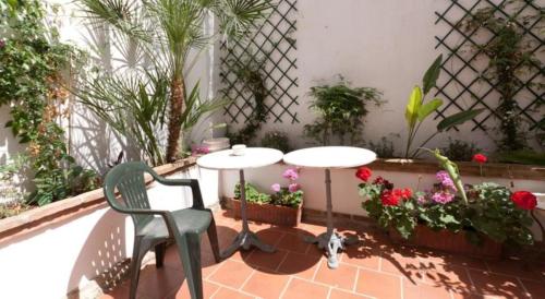 a patio with a table and a chair and flowers at Hotel Central Boutique in Marbella