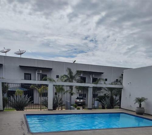 a swimming pool in front of a building at Hotel Boa Viagem in Barra do Garças