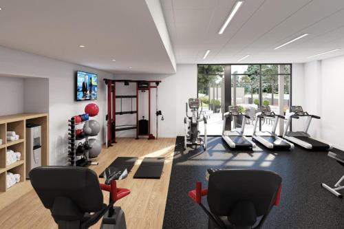 a gym with treadmills and cardio equipment in a room at Staybridge Suites Charlotte Arpt Area - Tyvola by IHG in Charlotte
