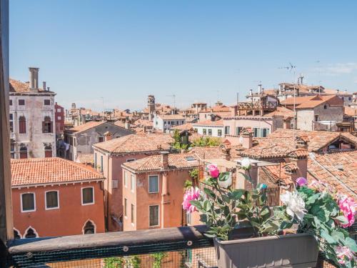 a view of a city from a balcony with flowers at Venice Palace Tintoretto by Wonderful Italy in Venice