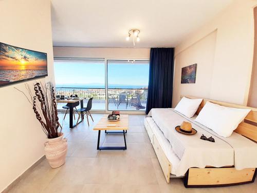 a hotel room with a bed and a view of the ocean at Manos Philoxenia in Kriopigi