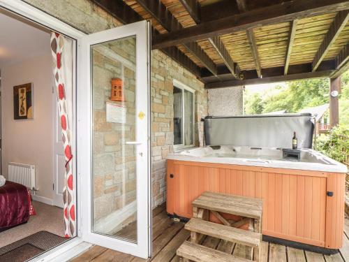 an outdoor kitchen with a sink and a window at Valley Lodge 52 in Callington
