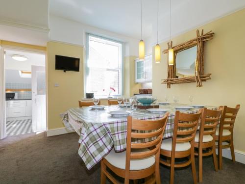 a kitchen and dining room with a table and chairs at Sefton House in Keswick