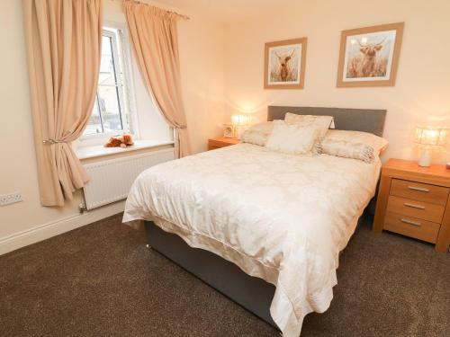 a bedroom with a large bed and a window at Old Bridge Inn in Carnforth