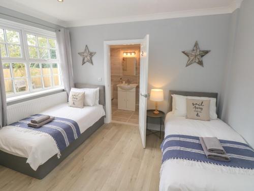 a bedroom with two beds and a window at Castle at The Hideaway in Tenby
