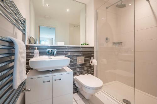 a bathroom with a sink and a toilet and a shower at Newquay Fistral Beach View in Newquay