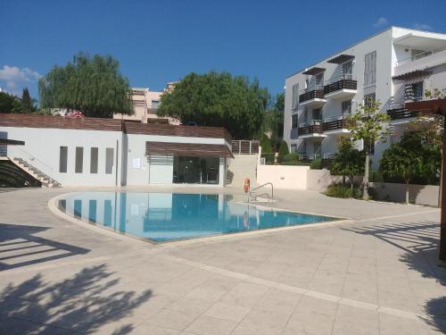 a swimming pool in front of a building at Amathousa Coastal Heights D202 in Limassol