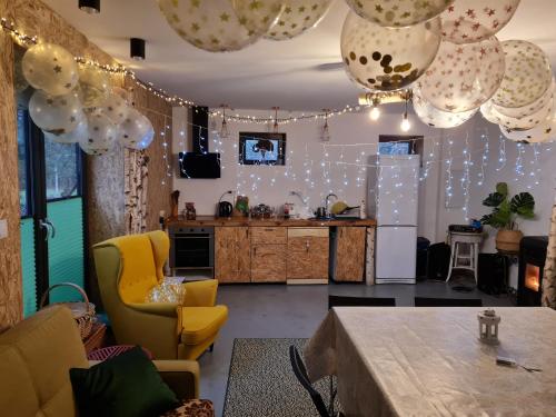 a kitchen with a table and some lights at Siedlisko Bolek in Nadrybie