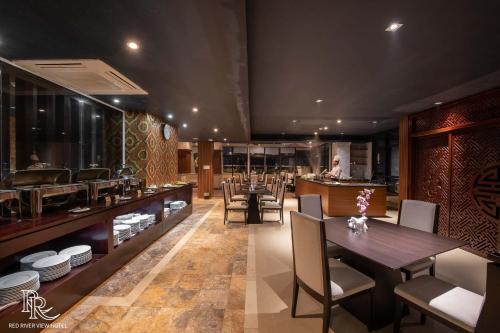 a restaurant with a dining room with tables and chairs at Red River View Hotel in Lao Cai