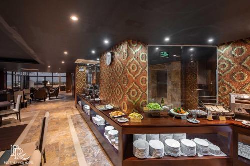 a restaurant with a buffet with food on display at Red River View Hotel in Lao Cai
