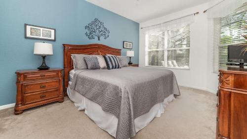 a bedroom with a bed and a dresser and a window at Luxury Villa with Private Pool on Windsor Hills Resort, Orlando Villa 4857 in Orlando
