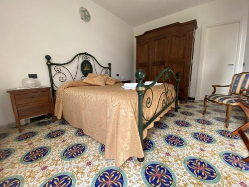 a bedroom with a bed and a chair at Villa Margherita in Levanto
