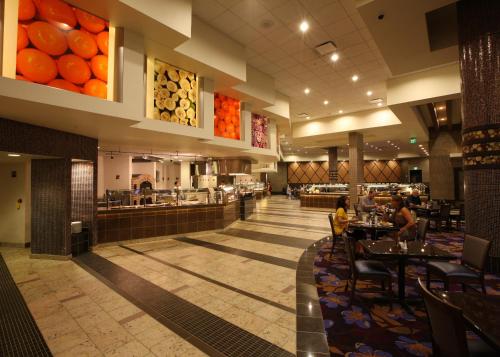 a restaurant with people sitting at tables in the cafeteria at Grand Falls Casino & Golf Resort in Larchwood
