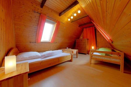 a large room with a bed and a window at WB2 Dat luette Hus in Dorum