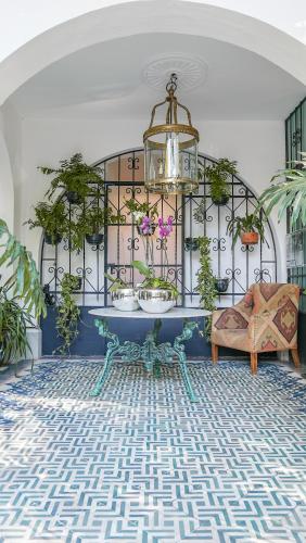 a living room with a table and potted plants at Orchid House Mexico City in Mexico City
