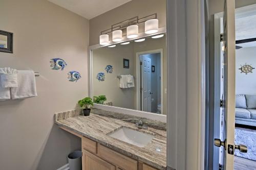 a bathroom with a sink and a large mirror at Swim, Golf, Play - Beachy River Oaks Condo! in Myrtle Beach