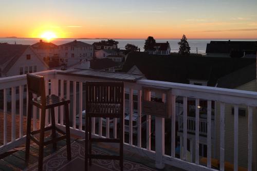 two chairs on a balcony watching the sunset at Sunrise Deck in Old Orchard Beach