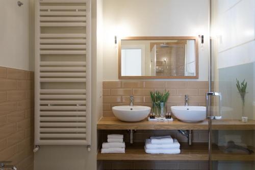 a bathroom with two sinks and a mirror at GMarconi Suites in Campobasso