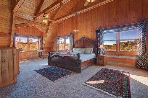 Un dormitorio con una cama en una cabaña de madera. en Stunning Cabin: 7 Acres, 360 Views, 20min to Park!, en Sevierville