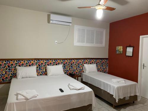 En eller flere senger på et rom på Viva Barê Pousada