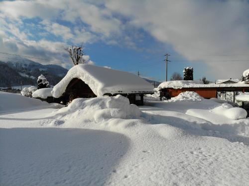 a pile of snow on top of a house at Wellnesshaus Reichelt in Radstadt