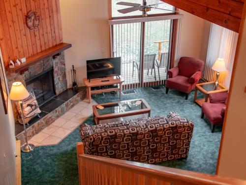 a living room with a couch and a fireplace at Fairmont Hot Springs Resort in Fairmont Hot Springs