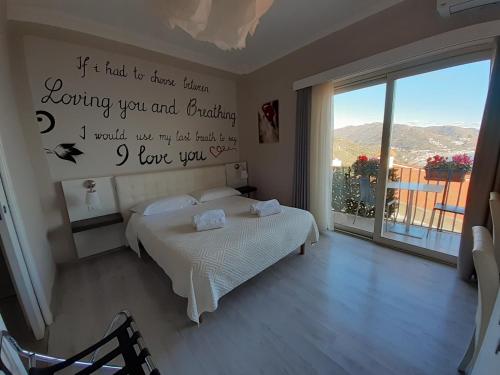 a bedroom with a bed with a sign on the wall at Athena Charming Rooms in Taormina