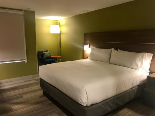 a bedroom with a large white bed in a room at Holiday Inn Express & Suites Pasadena - Los Angeles by IHG in Pasadena