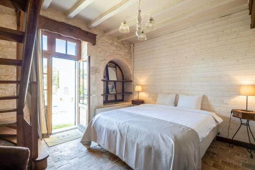 a bedroom with a bed and a large window at "Villa spacieuse à Sigoulès avec piscine privée" in Sigoulès