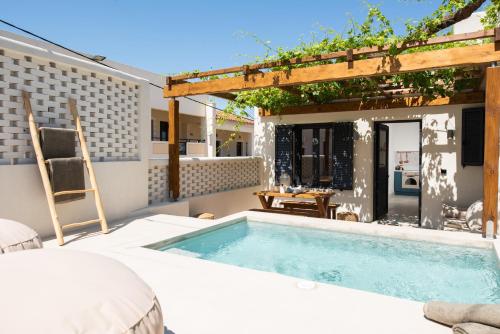 a swimming pool in the backyard of a house at Cretan Soul in Plataniás