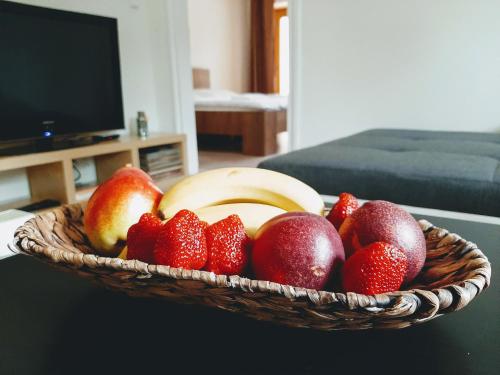a basket of fruit on a table in a living room at Penzion a Restaurace v Zátiší in Horní Lhota