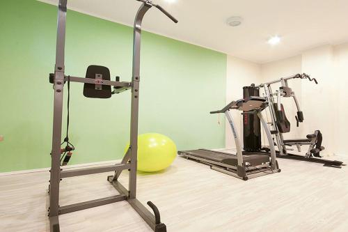 a gym with two tread machines and a exercise ball at Domador Rooms & Apartments in Budva