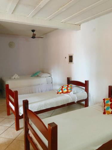 a room with three beds and two chairs at Nova Aldeia Buzios in Búzios