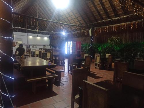 a dining room with a table and chairs and lights at Hotel Inversiones Napoles in Doradal