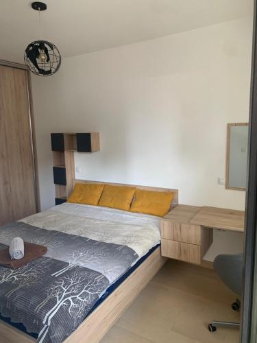 a bed in a room with a desk and a bed sidx sidx sidx at High End Apartments in Diamond Garden Building in Skopje