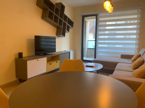 a living room with a table and a couch at High End Apartments in Diamond Garden Building in Skopje