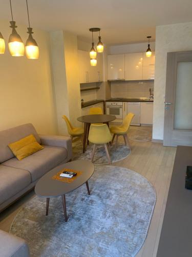 a living room with a couch and a table at High End Apartments in Diamond Garden Building in Skopje