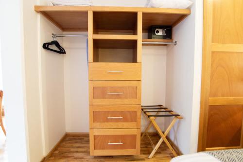 a room with a closet with wooden shelves at The Gallery in Mexico City