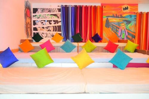 a group of colorful pillows sitting on a bed at Gypsy Diaries Varanasi in Varanasi