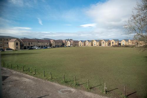 a large grass field with houses in the background at Newly renovated Old bakery House in Bath, 3 Bedroom, FREE Parking in Bath