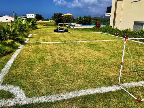 a soccer field with a net on the grass at Martimi Apartments - 200M from Drapanias Beach - Pool - Hot Tub - Sauna - BBQ in Kissamos