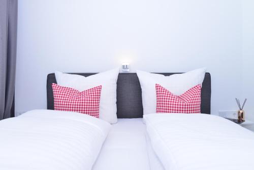 a bedroom with two red and white pillows on a bed at Villa Vanessa Kleinwalsertal in Mittelberg