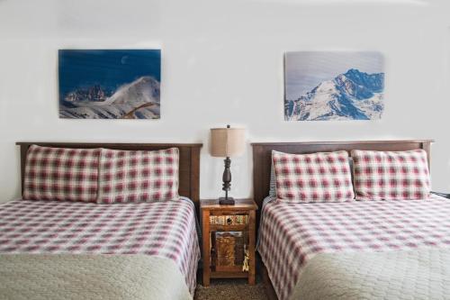 A bed or beds in a room at Mt Williamson Motel and Basecamp