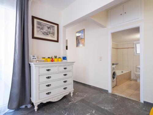 a bathroom with a white dresser and a toilet at Luxury Apts Heraklion Center in Heraklio Town