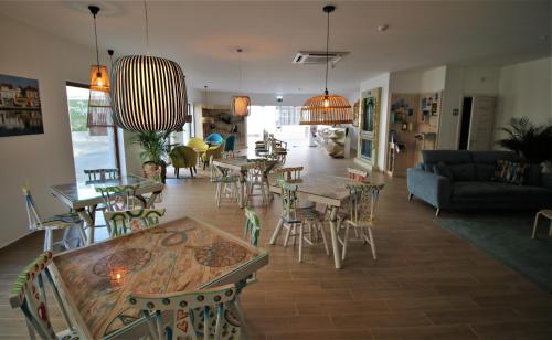 a living room with tables and chairs and a couch at Authentic Tavira Hotel in Tavira