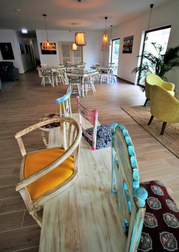 a room with chairs and a dining room with tables at Authentic Tavira Hotel in Tavira