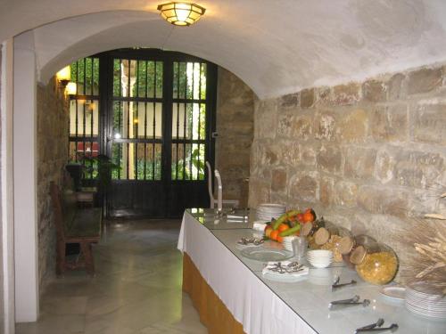 a kitchen with a counter with a stone wall at Palacio de la Rambla in Úbeda